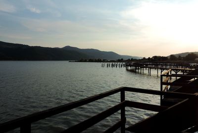 Pier over lake against sky