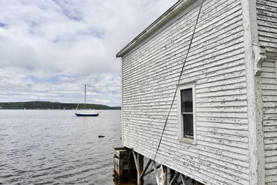 View of building by sea against sky