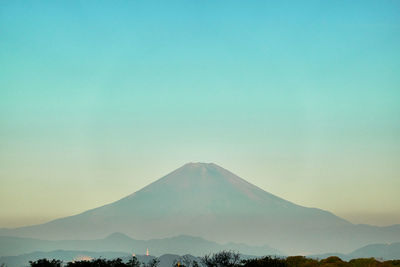 Scenic view of mountains against blue sky