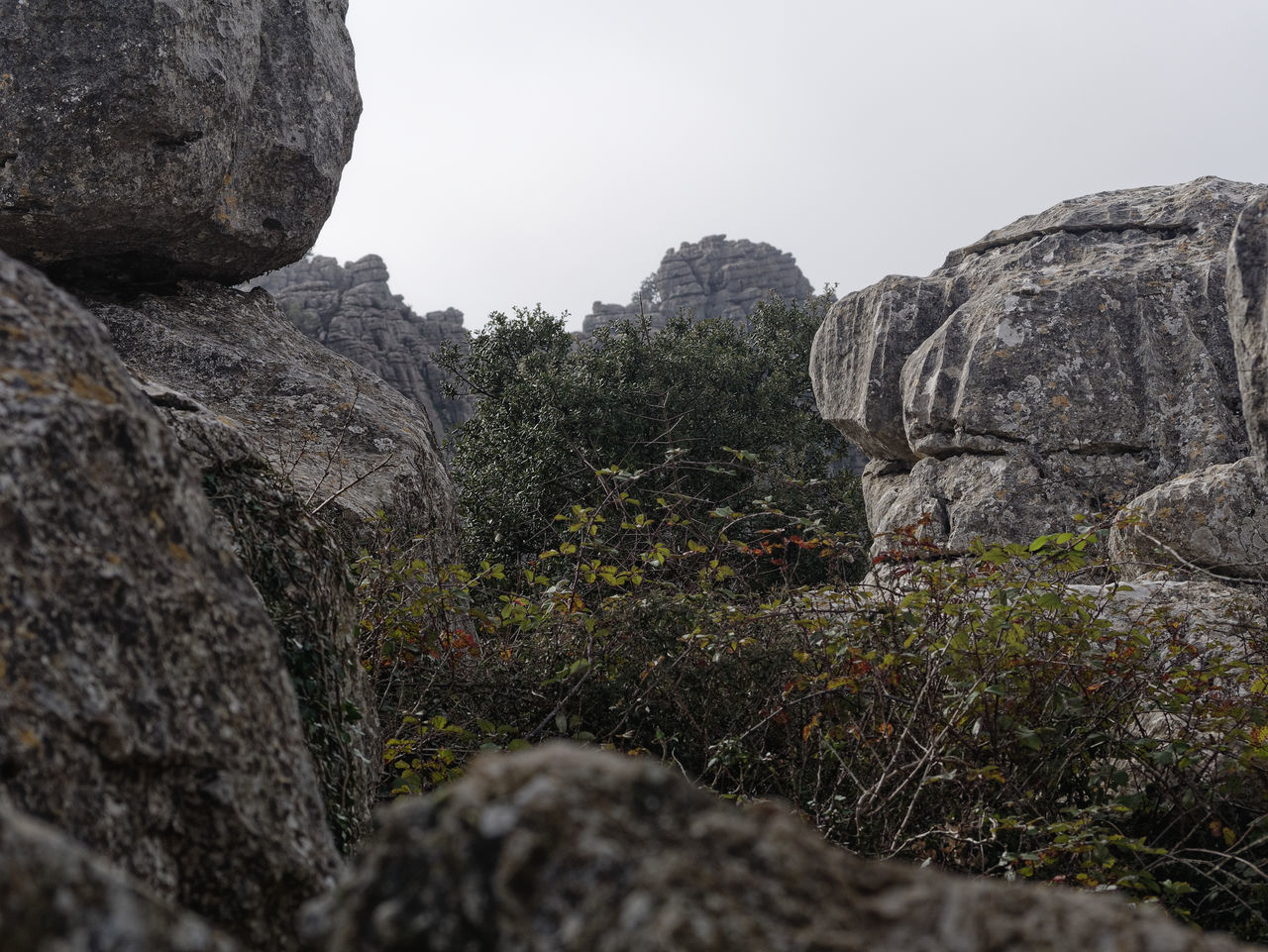 ROCK FORMATION ON MOUNTAIN AGAINST SKY