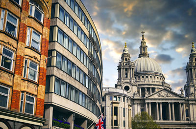 Low angle view of buildings against cloudy sky