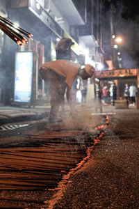 Man working on road at night