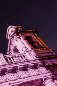 Low angle view of illuminated building against sky at night