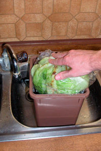 Midsection of man preparing food in kitchen at home