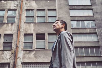 Low angle view of young man in window