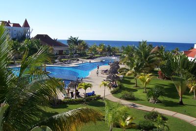 High angle view of palm trees by sea against clear sky