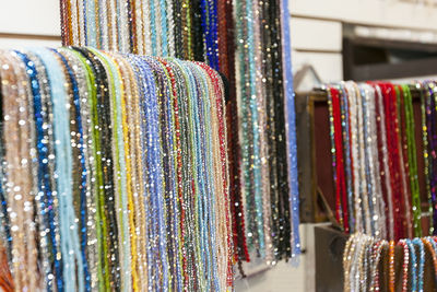 A lot of strands of beads of many colors