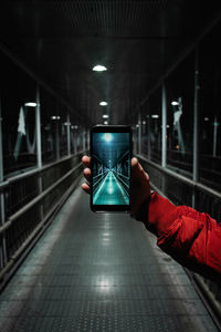Person holding smart phone in tunnel