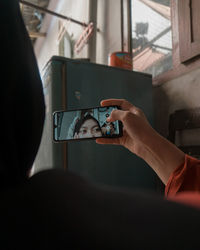 Cropped hand of man using mobile phone