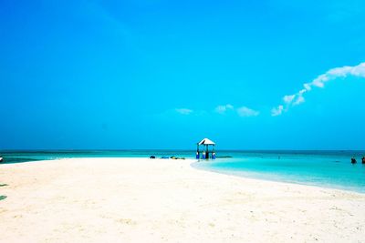 View of beach against blue sky