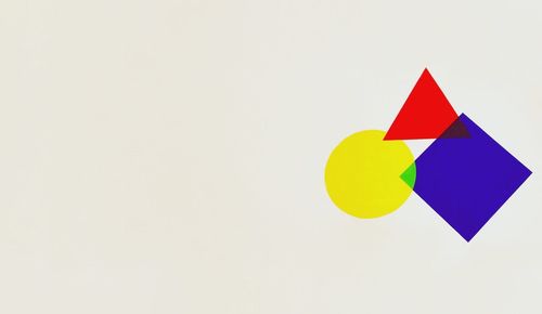 Close-up of colorful object over white background
