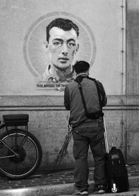 Portrait of young man standing against bus