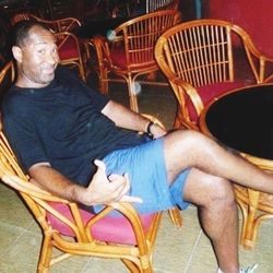 Rear view of man sitting on bench