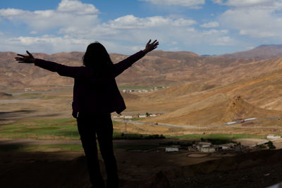 Rear view of man on landscape against sky