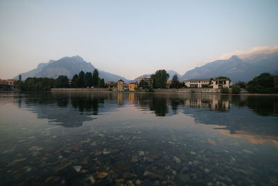 Scenic view of lake with houses in background