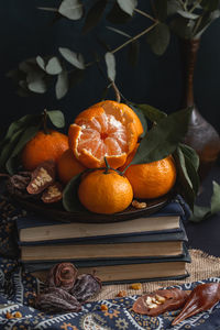 Close-up of orange fruits in basket on table