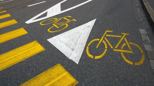 High angle view of bicycle parking signs on street