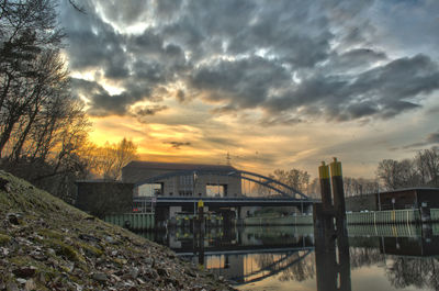 Built structure against cloudy sky at sunset