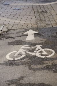 High angle view of arrow sign on road