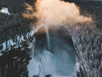 Scenic view of waterfall in forest during winter