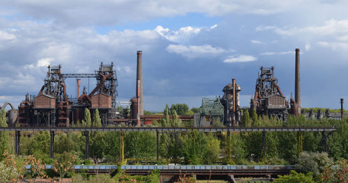 Abandoned factory against sky