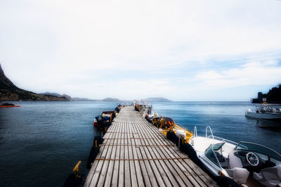 Pier over sea against sky