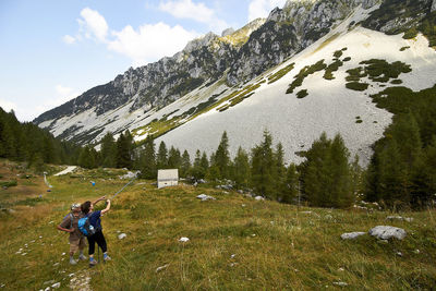 Full length of person on snowcapped mountains against sky