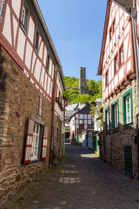 Narrow paved road in monreal, germany with löwenburg in the background