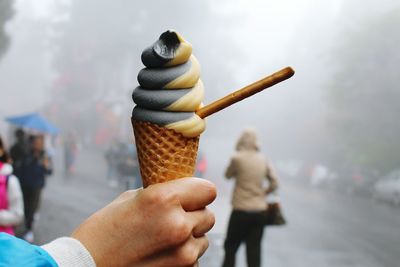 Close-up of hand holding ice cream cone