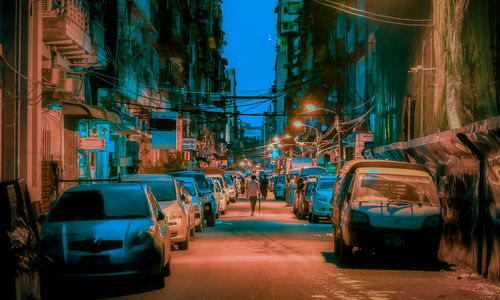Cars on city street at night