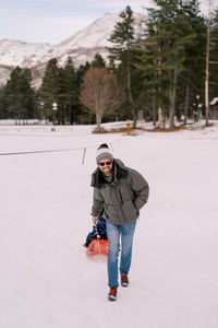 Man skiing on snow covered field