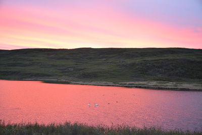Scenic view of field against sky during sunset