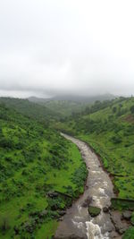 Scenic view of green landscape against sky