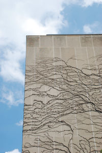 Low angle view of building against cloudy sky