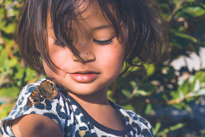 Close-up of cute girl looking down