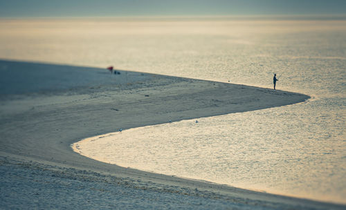 People on beach against sky