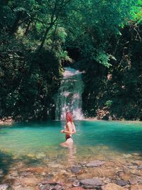 Full length of man sitting in forest