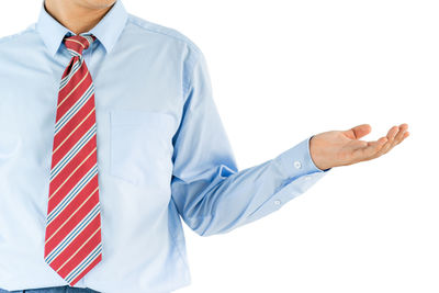 Midsection of man standing against white background