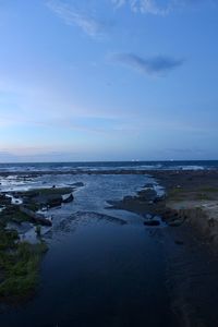 Scenic view of sea against sky at dusk