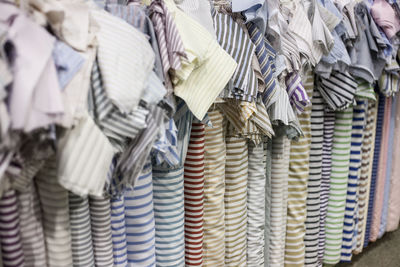 Close-up of colorful fabrics arranged in store for sale