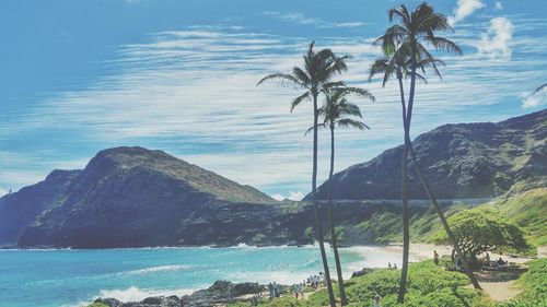 Scenic view of sea and mountains against sky