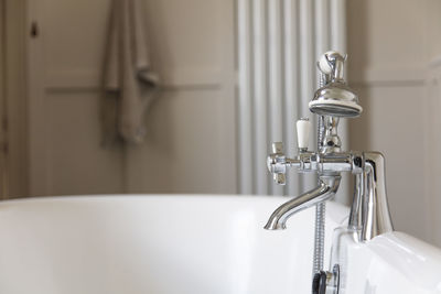 Close-up of faucet in bathroom at home