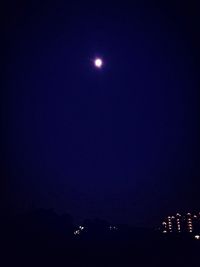 Low angle view of illuminated moon in sky