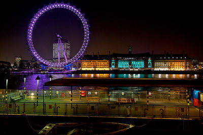 Illuminated ferris wheel at night