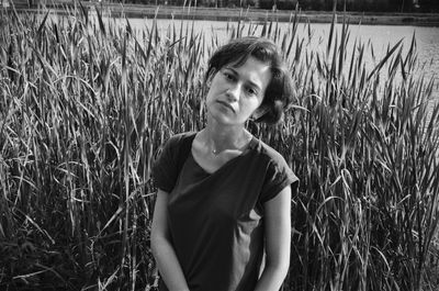 Portrait of young woman standing on field