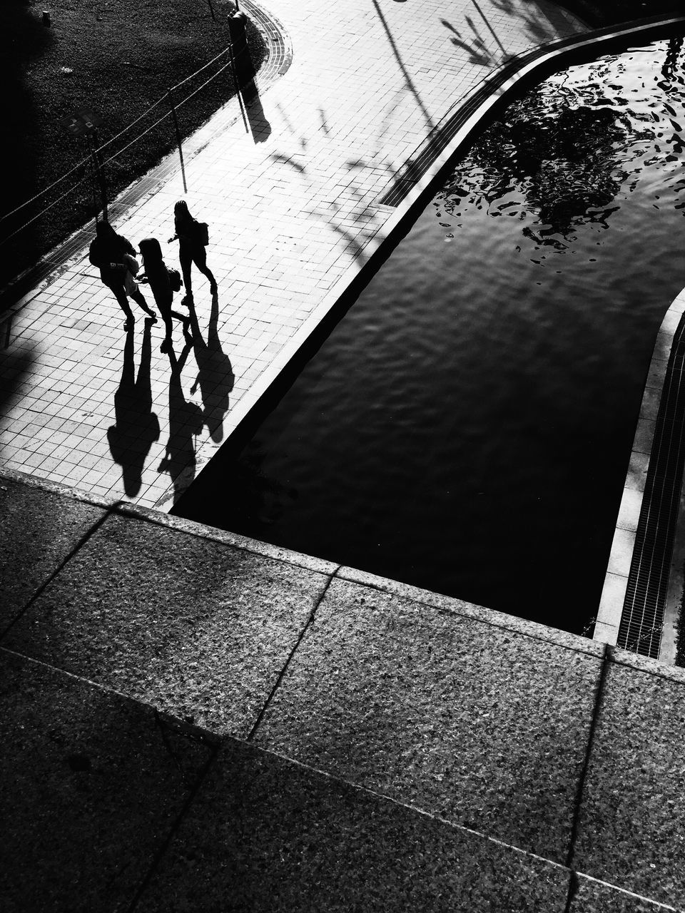 HIGH ANGLE VIEW OF WOMAN WALKING ON ROAD