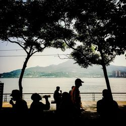 People sitting on tree trunk