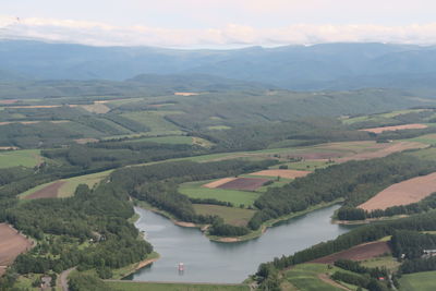 Aerial view of landscape and river against sky