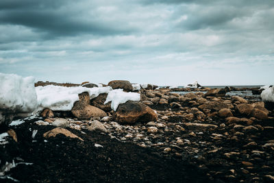 Rocks on beach against sky