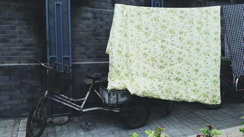 Bicycle parked by wall